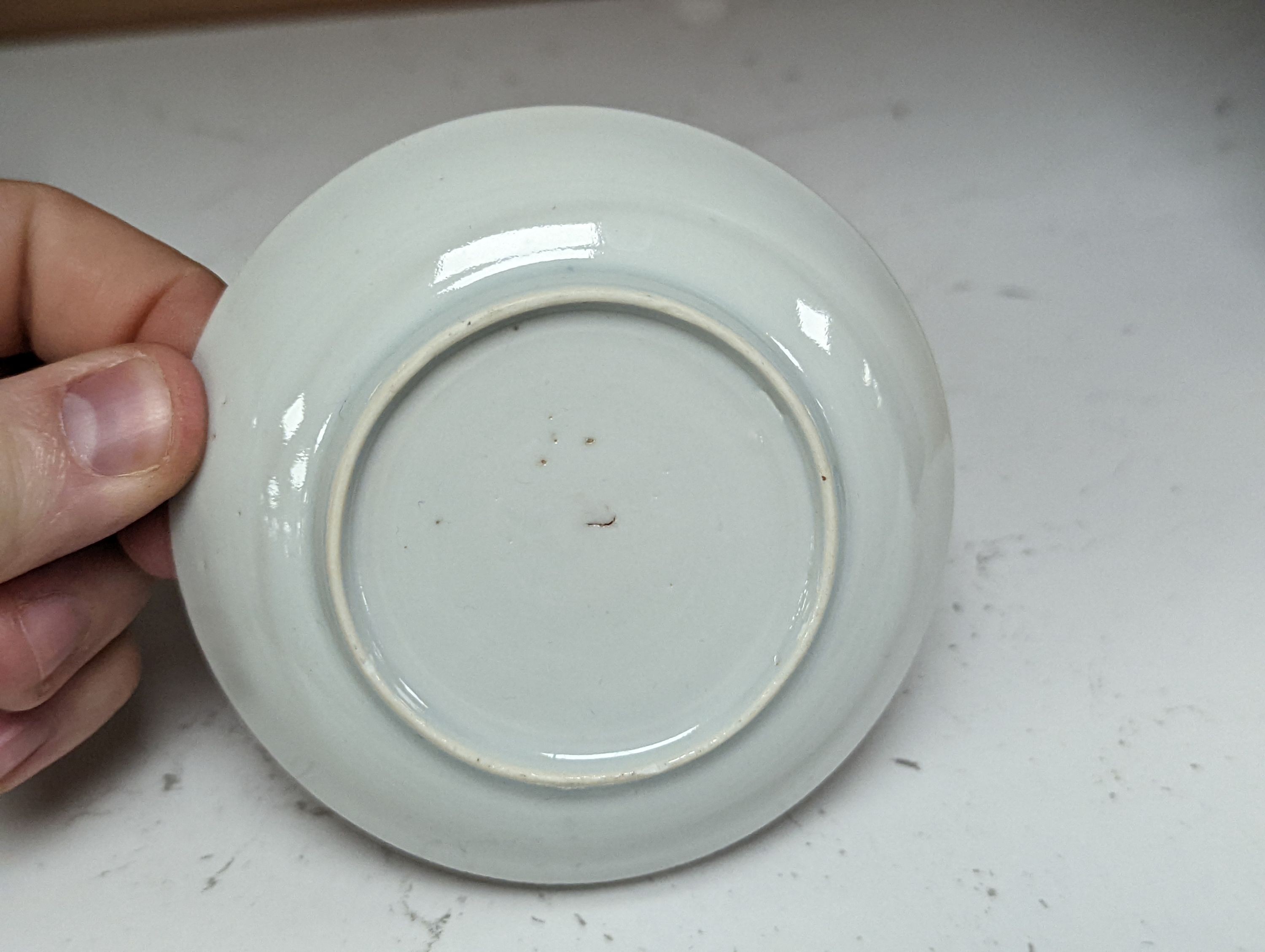 Seven 18th century Chinese saucer dishes, largest 14 cms diameter.
